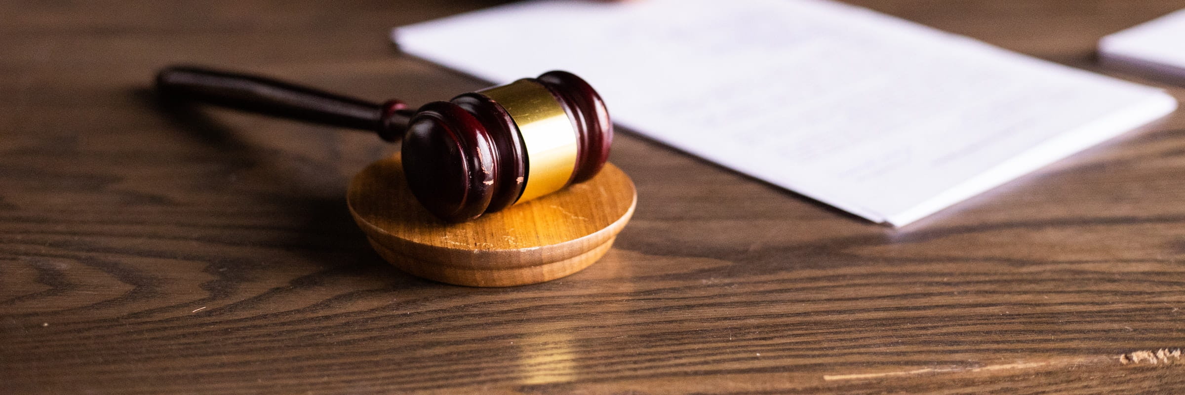 Legal. Gavel and papers on wooden desk.